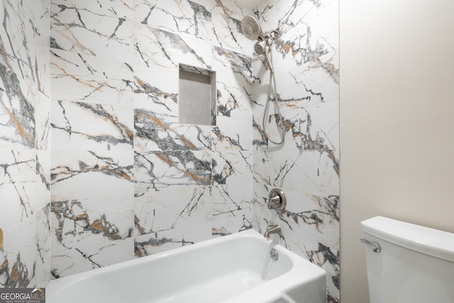 bathroom featuring washtub / shower combination and toilet