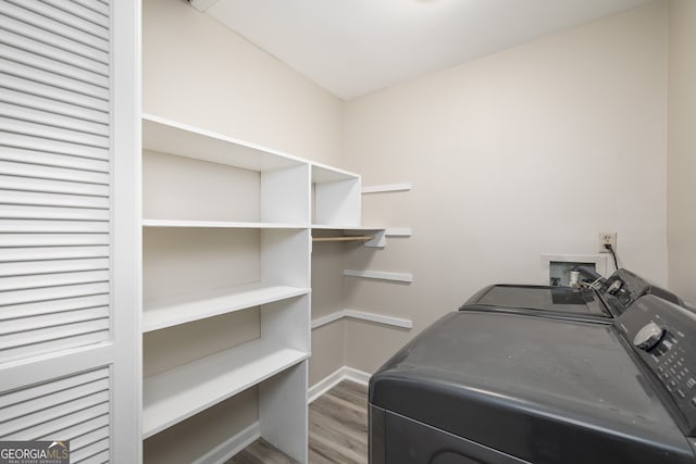 laundry area featuring hardwood / wood-style floors and separate washer and dryer