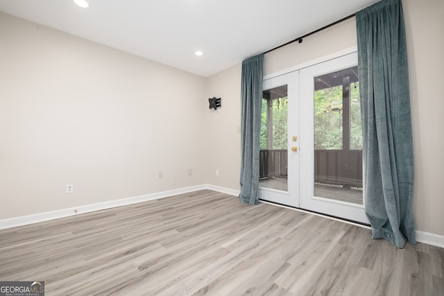 empty room featuring light hardwood / wood-style flooring and french doors