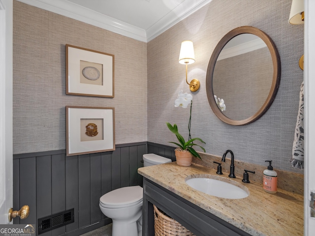 bathroom featuring vanity, toilet, and ornamental molding