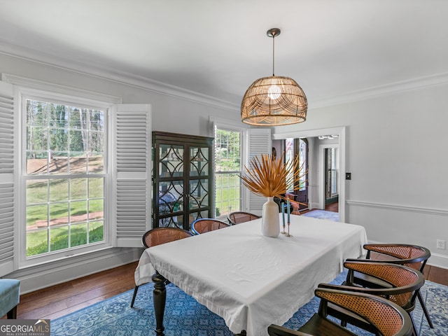 dining room with wood-type flooring and ornamental molding