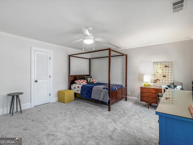 carpeted bedroom featuring ceiling fan and ornamental molding