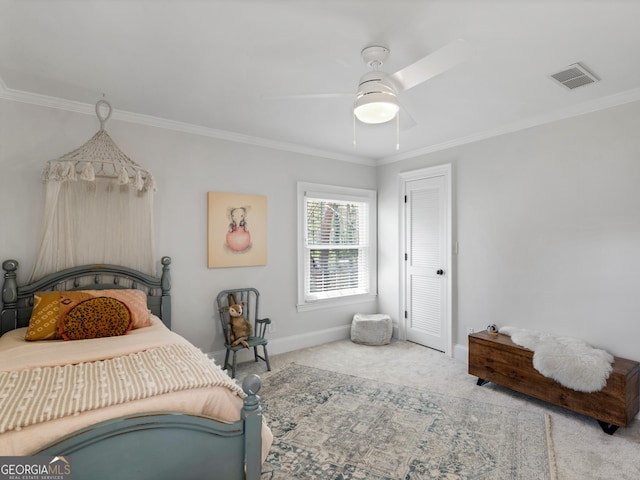 carpeted bedroom with ceiling fan and ornamental molding