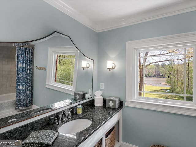 bathroom featuring shower / bath combo with shower curtain, vanity, and ornamental molding