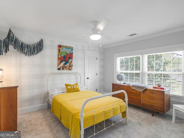 bedroom with carpet flooring, ceiling fan, and crown molding