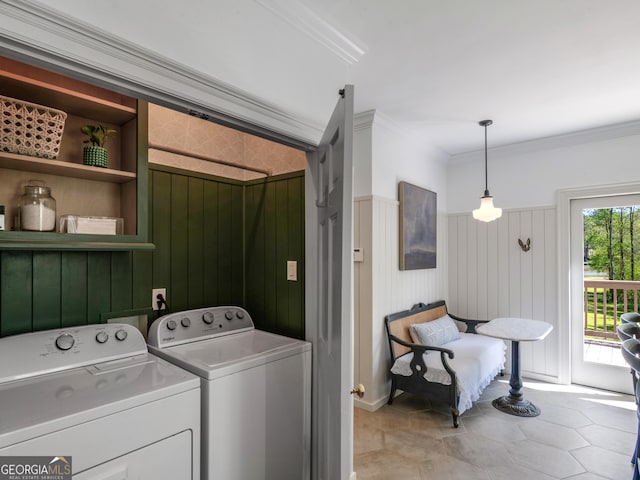 washroom featuring washing machine and dryer, wood walls, and ornamental molding