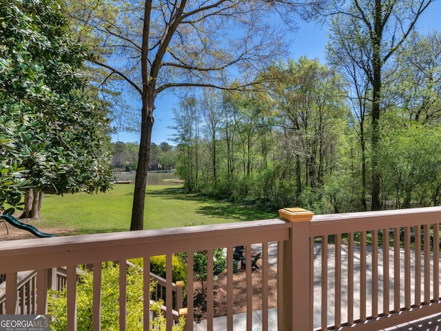 wooden terrace featuring a yard