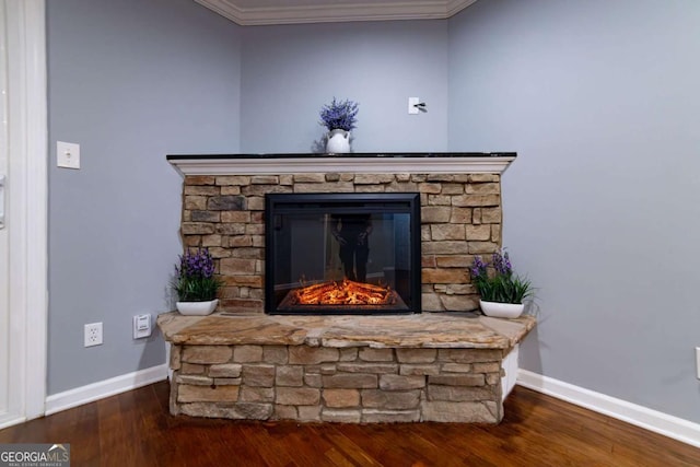 interior details with wood-type flooring, ornamental molding, and a fireplace