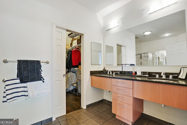 bathroom with vanity, tile patterned floors, and a shower with door