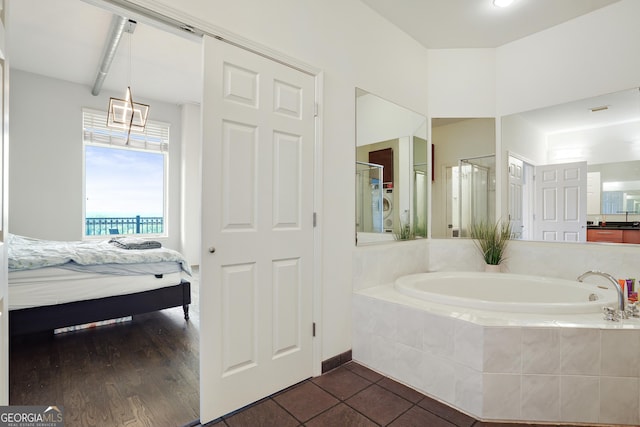 bathroom featuring tile patterned floors and separate shower and tub