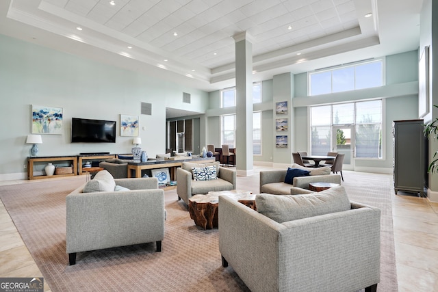 tiled living room with a tray ceiling and a towering ceiling