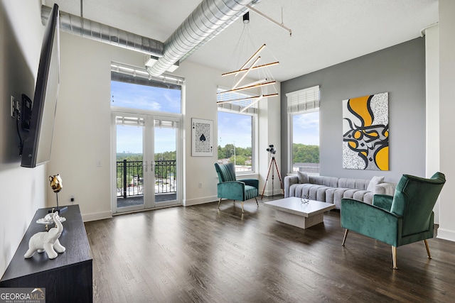 interior space featuring a notable chandelier, dark hardwood / wood-style flooring, and french doors