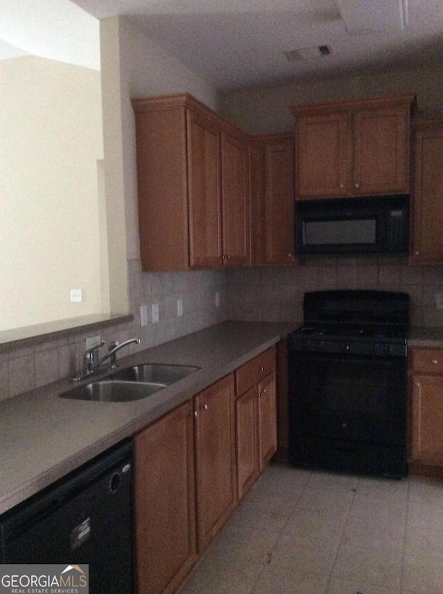 kitchen with black appliances, decorative backsplash, light tile patterned floors, and sink