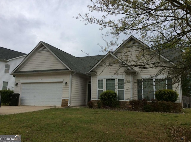 view of front of home with a garage and a front lawn