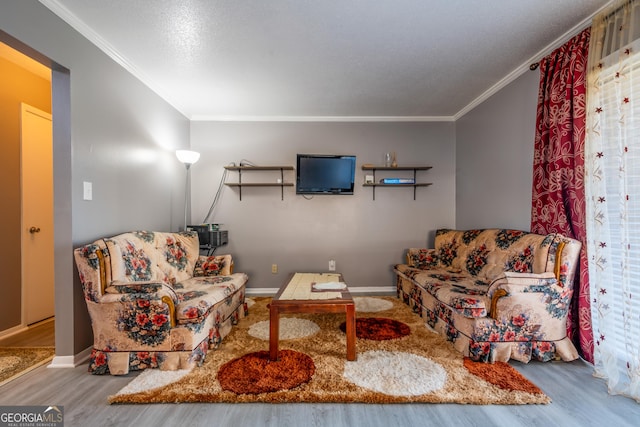 living room with crown molding and hardwood / wood-style floors