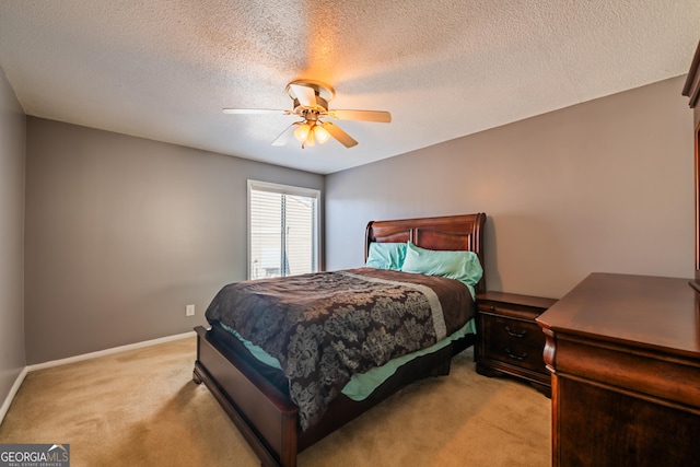 bedroom featuring ceiling fan, a textured ceiling, and light carpet