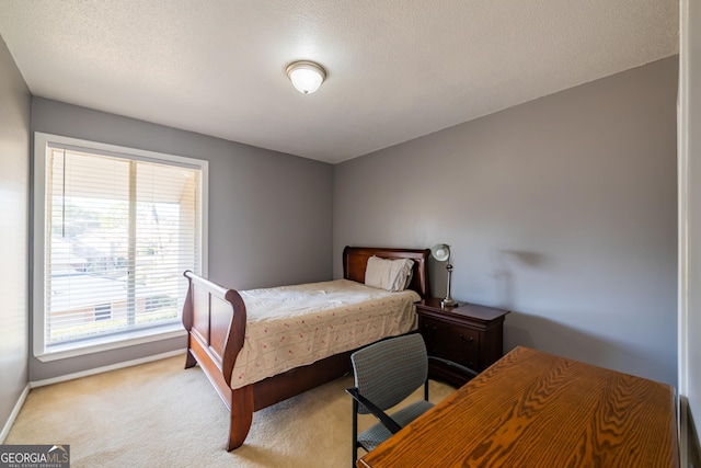 carpeted bedroom featuring a textured ceiling