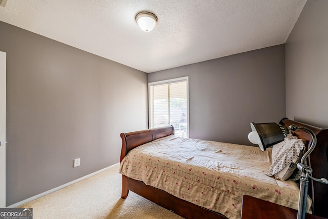 bedroom with carpet flooring and a textured ceiling