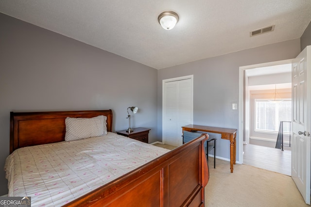 bedroom featuring light carpet and a closet