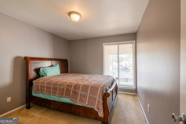 carpeted bedroom with multiple windows and a textured ceiling