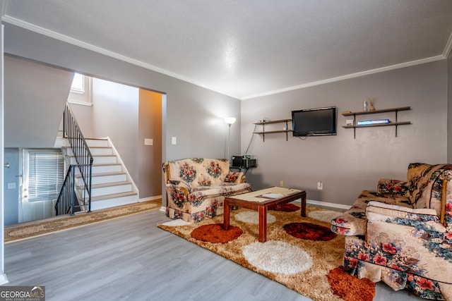 living room with hardwood / wood-style flooring and ornamental molding