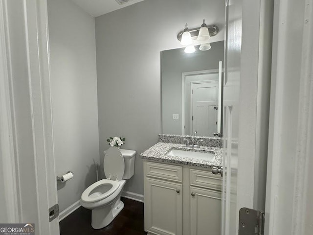 bathroom featuring vanity and toilet