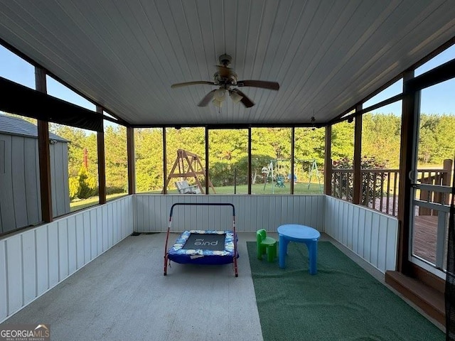 unfurnished sunroom with ceiling fan, wooden ceiling, and vaulted ceiling