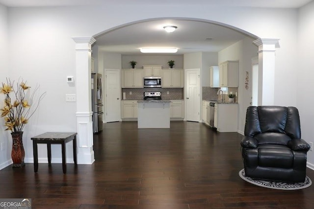 living room with dark hardwood / wood-style floors and sink