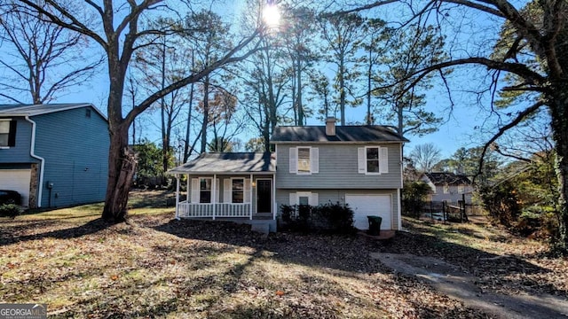 split level home with a garage and a porch