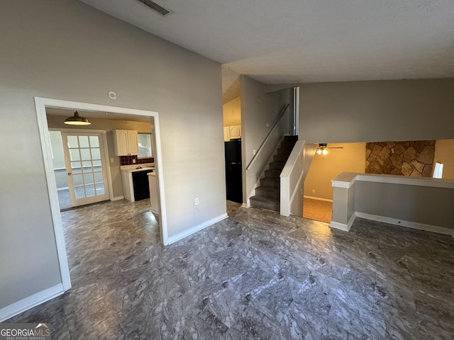 unfurnished living room featuring ceiling fan