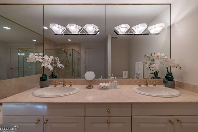 bathroom featuring vanity and a shower with door