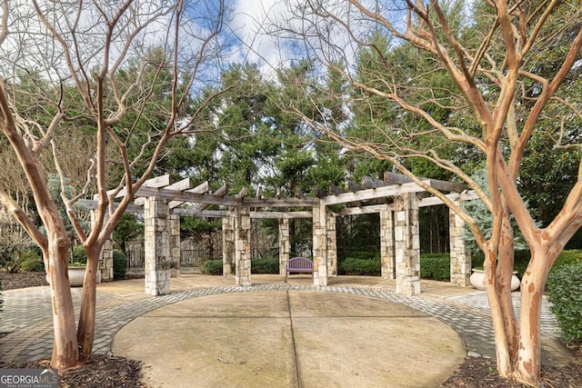 view of community featuring a pergola and a patio area