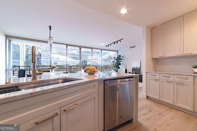 kitchen featuring dishwasher, tasteful backsplash, white cabinets, and light hardwood / wood-style floors