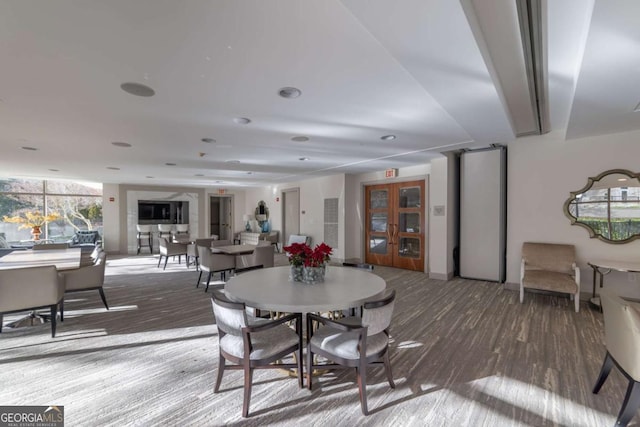 dining space featuring hardwood / wood-style flooring and french doors