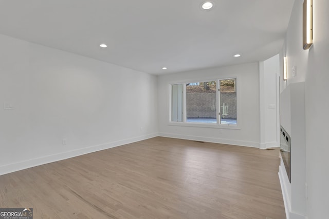 unfurnished living room featuring light hardwood / wood-style floors