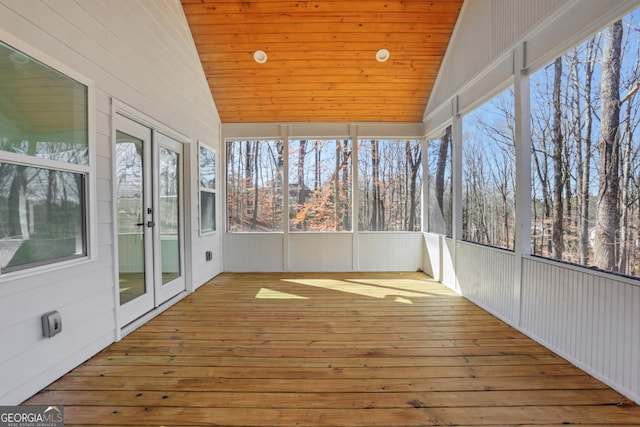 unfurnished sunroom featuring wood ceiling and lofted ceiling