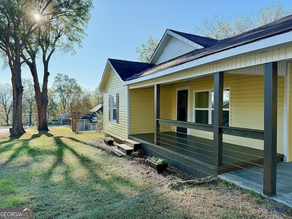 view of side of home with a lawn