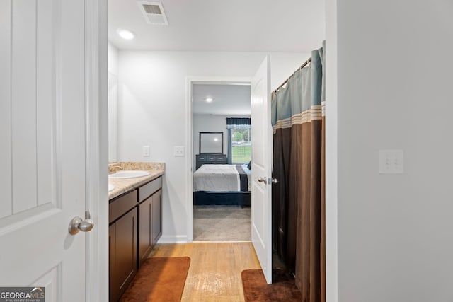 bathroom featuring vanity and hardwood / wood-style flooring