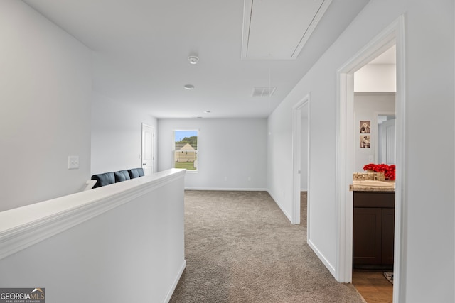 hallway featuring light carpet