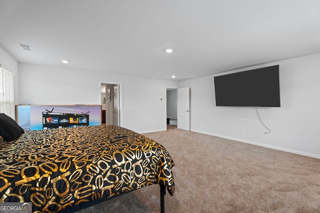 bedroom with carpet floors and connected bathroom