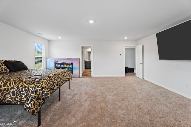 carpeted bedroom featuring ensuite bath