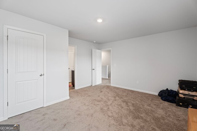 unfurnished bedroom featuring carpet