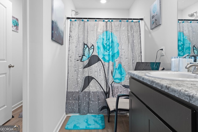 bathroom featuring a shower with curtain, vanity, and hardwood / wood-style flooring