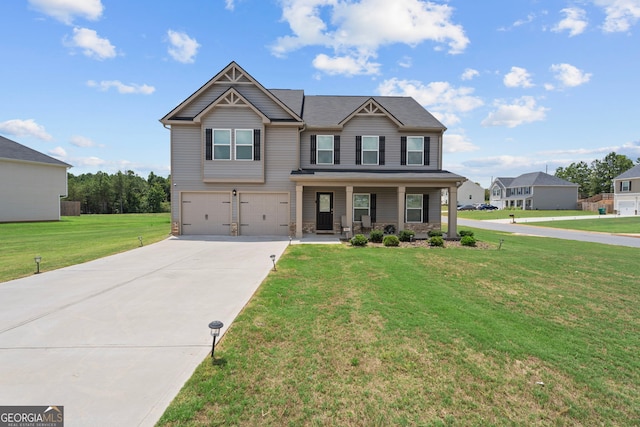 craftsman inspired home with covered porch, a front yard, and a garage