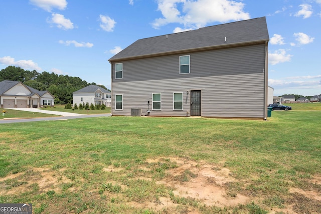 back of house featuring a lawn and central AC