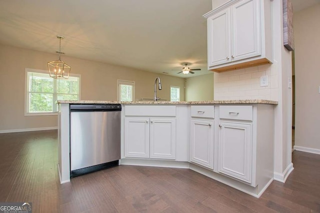 kitchen with tasteful backsplash, dishwasher, and white cabinets