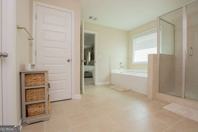 bathroom with tile patterned flooring and independent shower and bath