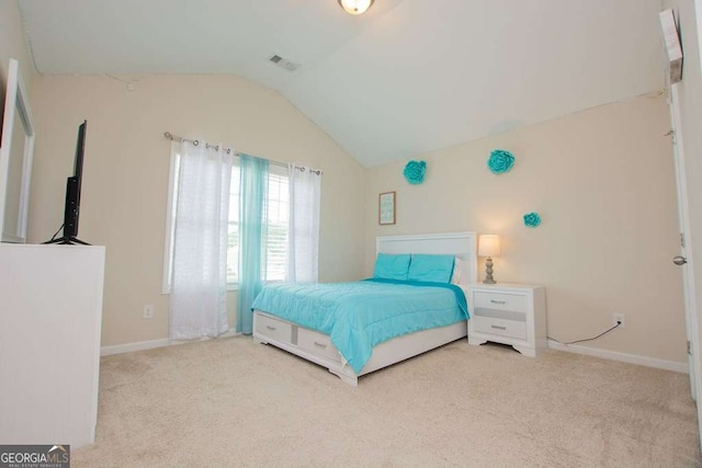 bedroom featuring light carpet and lofted ceiling