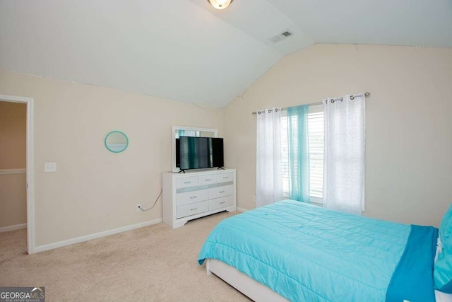 carpeted bedroom featuring vaulted ceiling