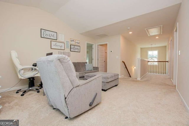 interior space with light carpet and vaulted ceiling